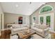 Spacious living room with French doors, large windows, and an open floor plan at 10311 Windtree Ln, Charlotte, NC 28215