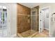 Bathroom featuring a tile shower, shower head, and decorative niche for shampoo and other bathing essentials at 10311 Windtree Ln, Charlotte, NC 28215