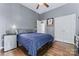 This bedroom has a mini fridge and ample storage with a dresser and closet at 107 Glenmont Ct, Mooresville, NC 28117