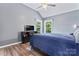 This is a well-lit bedroom features hardwood floors, tray ceilings, and a mounted TV at 107 Glenmont Ct, Mooresville, NC 28117