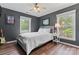 This charming bedroom has hardwood floors, and two large windows flood the room with natural light at 107 Glenmont Ct, Mooresville, NC 28117