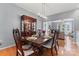 Cozy dining room featuring hardwood floors, modern lighting, and view into the living area at 107 Glenmont Ct, Mooresville, NC 28117