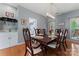 Elegant dining room featuring hardwood floors, classic furniture, and ample seating at 107 Glenmont Ct, Mooresville, NC 28117