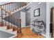 Inviting foyer featuring hardwood floors, staircase with decorative iron railing, and stylish decor at 107 Glenmont Ct, Mooresville, NC 28117