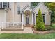 Charming front entrance with a covered porch, decorative columns, and well-manicured landscaping at 107 Glenmont Ct, Mooresville, NC 28117