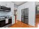 Well-equipped kitchen featuring stainless steel appliances, white cabinets, and access to dining room at 107 Glenmont Ct, Mooresville, NC 28117