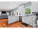 Bright kitchen showcasing white cabinets, stainless steel appliances, and hardwood floors at 107 Glenmont Ct, Mooresville, NC 28117