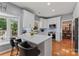 Modern kitchen featuring white cabinetry, stainless steel appliances, marble countertops, and a stylish island at 107 Glenmont Ct, Mooresville, NC 28117