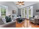 Bright living room featuring hardwood floors, large windows, and neutral paint at 107 Glenmont Ct, Mooresville, NC 28117