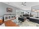 Inviting living room featuring a comfortable gray sectional, stylish rug, and hardwood floors at 107 Glenmont Ct, Mooresville, NC 28117
