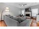 Spacious living room with a gray sectional, a fireplace, and a mounted television at 107 Glenmont Ct, Mooresville, NC 28117