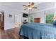 This main bedroom features tray ceiling, hardwood floors, and an adjoining bathroom with a soaking tub and shower at 107 Glenmont Ct, Mooresville, NC 28117