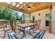 Charming outdoor dining area on a covered deck, featuring a stylish table and chairs for al fresco meals at 107 Glenmont Ct, Mooresville, NC 28117