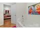 Bright bathroom with white tub, a shower head and religious art on the walls at 10816 Pointer Ridge Dr, Charlotte, NC 28214