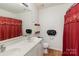 Bathroom featuring a double vanity, neutral walls, and a shower with a red shower curtain at 10816 Pointer Ridge Dr, Charlotte, NC 28214