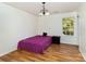 Modest bedroom features a purple bed, wood floor, and an inviting window view at 10816 Pointer Ridge Dr, Charlotte, NC 28214