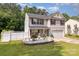 Charming two-story home with landscaped yard, white fence and fountain feature enhancing curb appeal at 10816 Pointer Ridge Dr, Charlotte, NC 28214