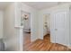 Hallway provides access to a bedroom and bathroom, both with wood floors at 10816 Pointer Ridge Dr, Charlotte, NC 28214
