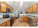 Functional kitchen with stainless steel appliances, light cabinets, and adjacent dining area at 10816 Pointer Ridge Dr, Charlotte, NC 28214