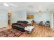 Cozy living room features a black leather sofa, chandelier, and adjacent kitchen view at 10816 Pointer Ridge Dr, Charlotte, NC 28214