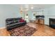 Spacious living room featuring fireplace, hardwood floors and natural light from large windows at 10816 Pointer Ridge Dr, Charlotte, NC 28214