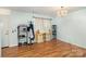 Open living room with hardwood floors, chandelier, and a view of the front door at 10816 Pointer Ridge Dr, Charlotte, NC 28214