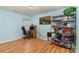 Room features wood floors, metal shelves and a workstation next to a window at 10816 Pointer Ridge Dr, Charlotte, NC 28214