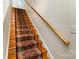 Stairway with wood steps and patterned carpet, complemented by a wooden handrail at 10816 Pointer Ridge Dr, Charlotte, NC 28214