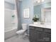 This bathroom features a single sink, grey vanity, and a shower-tub combo with white surround at 11034 Engelmann Ln, Charlotte, NC 28269