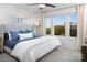 A cozy bedroom filled with natural light showcasing the large windows and soft furnishings for a comfortable retreat at 11034 Engelmann Ln, Charlotte, NC 28269