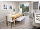 Bright dining area with a table, bench, and chairs, flowing to an outdoor space at 11034 Engelmann Ln, Charlotte, NC 28269