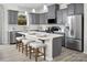 This home features an open kitchen with an island, gray cabinetry, and stainless steel appliances at 11034 Engelmann Ln, Charlotte, NC 28269