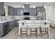 This home features an open kitchen with an island, grey cabinetry and stainless steel appliances at 11034 Engelmann Ln, Charlotte, NC 28269