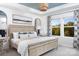 This main bedroom offers a serene retreat, featuring a wooden bed frame, decorative pillows, and ample natural light at 11034 Engelmann Ln, Charlotte, NC 28269