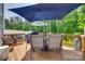 Outdoor back deck with patio furniture including table, chairs, grill and multiple sun umbrellas at 1195 Cavalier Ln, Rock Hill, SC 29730