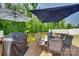 Spacious wooden deck with outdoor dining set, barbecue grill, and shade umbrellas overlooking backyard at 1195 Cavalier Ln, Rock Hill, SC 29730