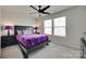 Bright bedroom with natural light, a ceiling fan, and a cozy bed with a vibrant purple blanket at 1195 Cavalier Ln, Rock Hill, SC 29730