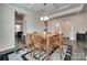 Open-concept dining room with wood floors, stylish area rug, and modern lighting at 1195 Cavalier Ln, Rock Hill, SC 29730