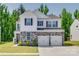 Charming two-story home featuring a stone facade, white siding, and a two-car garage at 1195 Cavalier Ln, Rock Hill, SC 29730