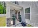 Inviting front porch with stone accents, decorative plants, and a well-lit entrance at 1195 Cavalier Ln, Rock Hill, SC 29730