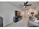 Spacious living room with neutral carpet, a modern ceiling fan, and a sleek entertainment center at 1195 Cavalier Ln, Rock Hill, SC 29730