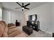 Comfortable living room featuring a plush couch, modern ceiling fan and a dark media center at 1195 Cavalier Ln, Rock Hill, SC 29730