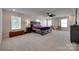 Bright main bedroom boasting neutral carpet, large windows, and a comfortable bed with stylish furnishings at 1195 Cavalier Ln, Rock Hill, SC 29730
