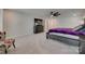 Spacious main bedroom featuring neutral carpet, a large window, and a comfortable bed with a decorative purple blanket at 1195 Cavalier Ln, Rock Hill, SC 29730