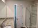 Bathroom featuring granite countertop, and glass shower doors with an open white paneled door at 1195 Winding Creek Rd, Salisbury, NC 28146