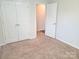 Bedroom with neutral carpet, white walls and paneled closet doors at 1195 Winding Creek Rd, Salisbury, NC 28146