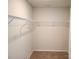 Walk-in closet featuring installed rack shelving, carpet floor and painted walls at 1195 Winding Creek Rd, Salisbury, NC 28146