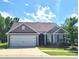 Charming single-story home features a two-car garage and well-maintained lawn at 1195 Winding Creek Rd, Salisbury, NC 28146