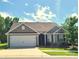 Charming single-story home with well-manicured lawn, two car garage, and beautiful curb appeal at 1195 Winding Creek Rd, Salisbury, NC 28146