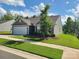 A well-maintained house showing a lovely lawn, complemented by blue skies with puffy clouds at 1195 Winding Creek Rd, Salisbury, NC 28146